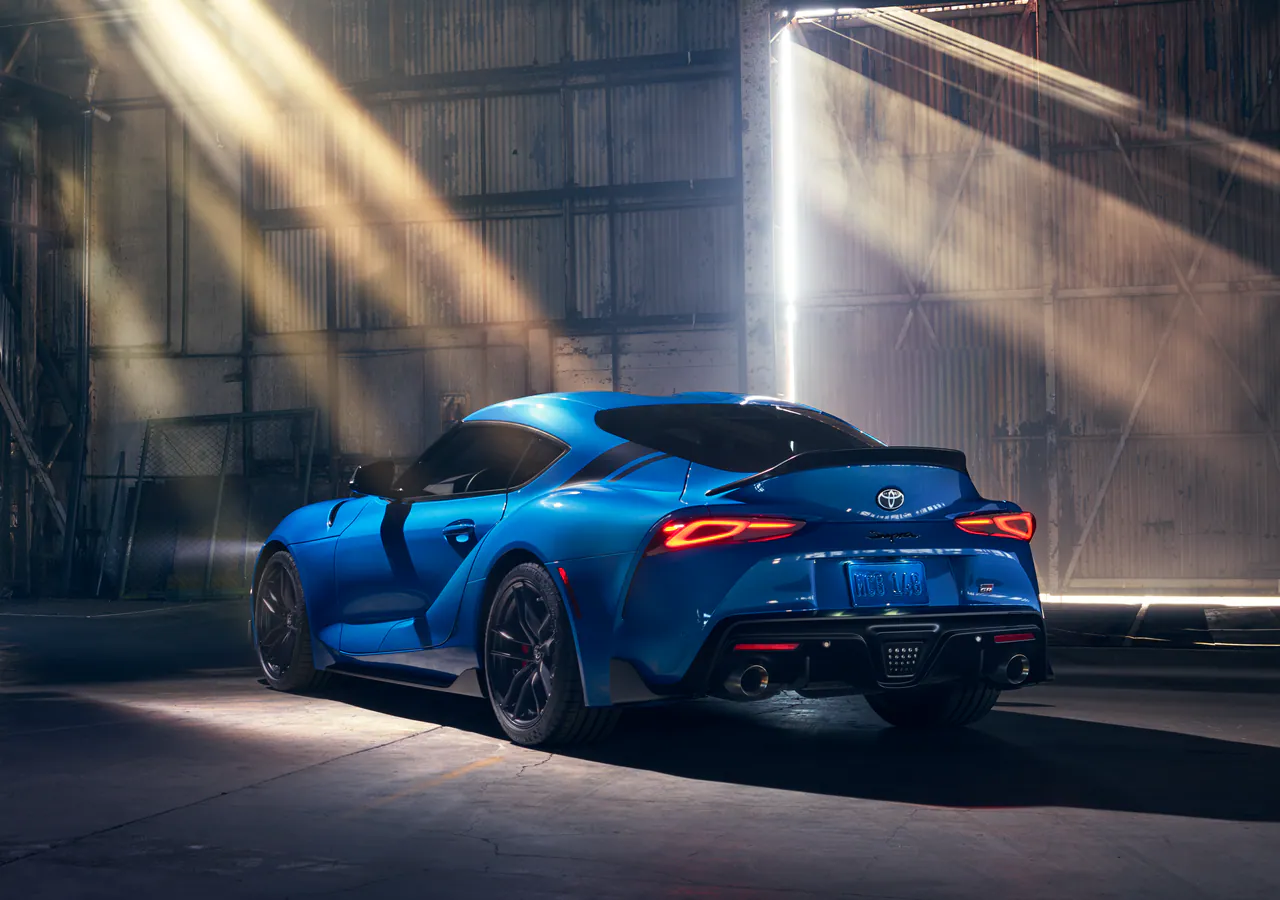 GR Supra in blue under shafts of light