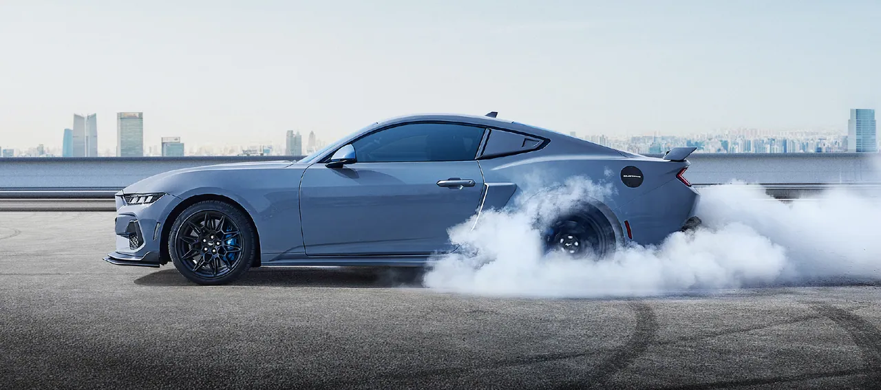 Ford Mustang GT doing a burnout, side view