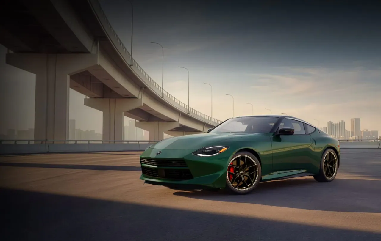 Nissan Z in green beneath an overpass at dusk
